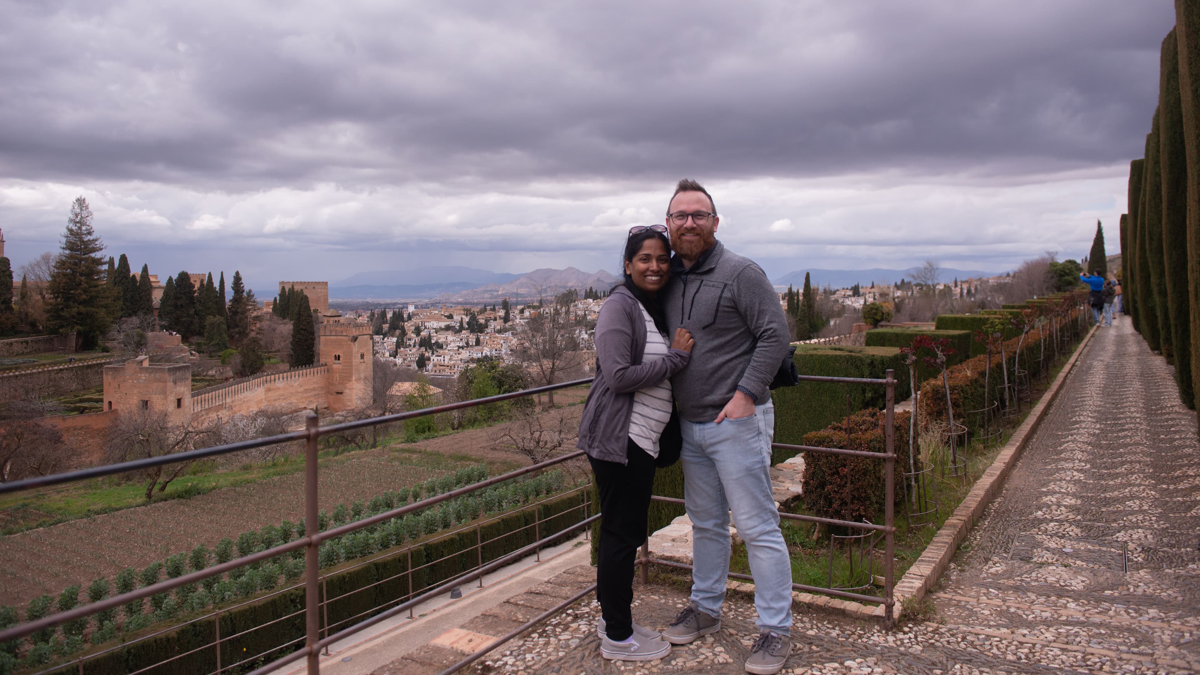 John and Biji standing together in the Alhambra overlooking Grenada